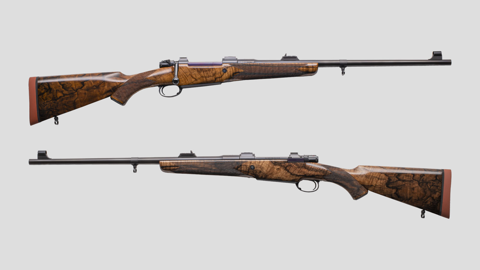 Two John Rigby & Co Big Game Lightweight Rifle's on a grey background. One showing the right-hand side and the other the left-hand side